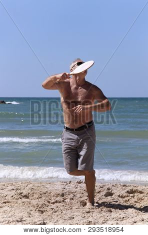 Handsome Grown Man Playing Tennis On The Beach