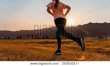 Asian Woman Enjoys Running Outside With Beautiful Summer Evening In The Countryside.