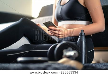 Online Workout Course, Personal Trainer Service Or Fitness App In Phone. Fit Woman Using Smartphone 