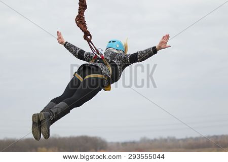 Belarus, Gomel, March 08, 2019. Jumping From The Bridge To The Rope.ropejumping.an Elderly Woman Jum