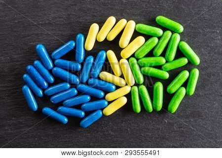 Lot Of Whole Blue Yellow And Green Sweet Licorice Comfit Flatlay On Grey Stone