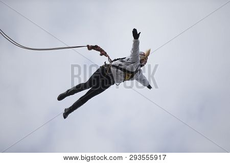 Belarus, Gomel, March 08, 2019. Jumping From The Bridge To The Rope.ropejumping.an Elderly Woman Jum