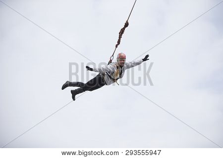 Belarus, Gomel, March 08, 2019. Jumping From The Bridge To The Rope.ropejumping.an Elderly Woman Jum