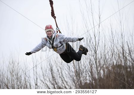 Belarus, Gomel, March 08, 2019. Jumping From The Bridge To The Rope.ropejumping.an Elderly Woman Jum