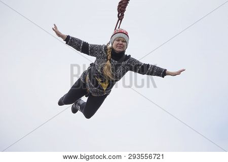 Belarus, Gomel, March 08, 2019. Jumping From The Bridge To The Rope.ropejumping.an Elderly Woman Jum