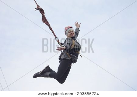 Belarus, Gomel, March 08, 2019. Jumping From The Bridge To The Rope.ropejumping.an Elderly Woman Jum
