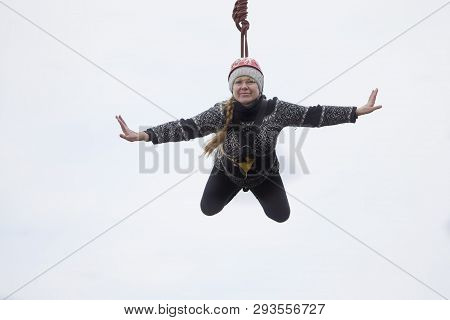 Belarus, Gomel, March 08, 2019. Jumping From The Bridge To The Rope.ropejumping.an Elderly Woman Jum