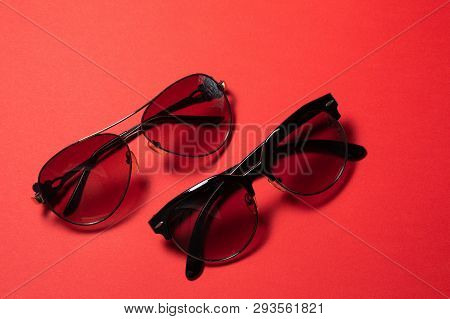 Sunglasses Lie On A Red Background, Close-up.