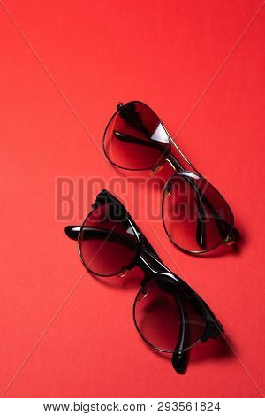 Sunglasses Lie On A Red Background, Close-up.