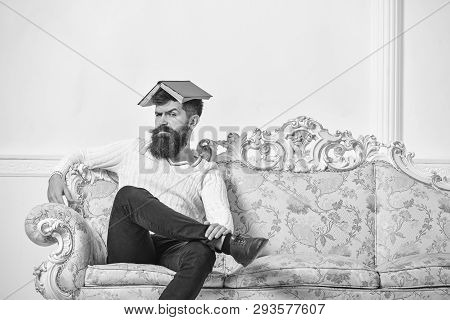 Macho Sits With Open Book On Head, Like Roof. Guy, Teacher Overdid With Teaching, Became Crazy Profe