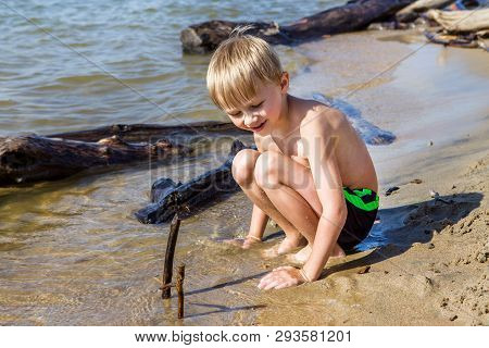 Kid Playing In The Sand On The Summer Beach