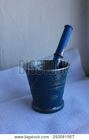 Ancient Blue Metal Mortar With Pestle On Linen Background. Old Home Kitchen Appliances For Grinding 