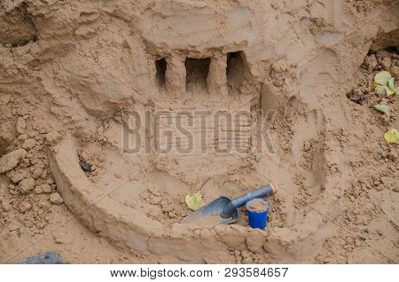 The Sand Castle And Tools In Cloudy Day