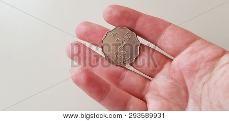 Close Up Of Two Hong Kong Dollars Coin On Human Hand