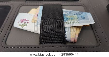 A Bunch Of Hryvnia Banknotes Folded Under Elastic Bandage In Black Pocket