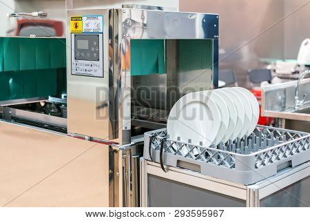 Close Up White Dish On Basket In Automatic Dishwasher Machine For Industrial