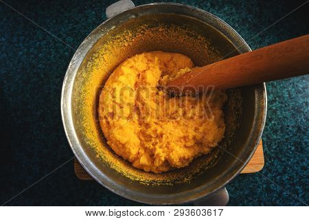Polenta Or Mamaliga And Beech Wood Stirrer In Cast Iron Pot (cooper Pot).  Traditional Dish Prepared