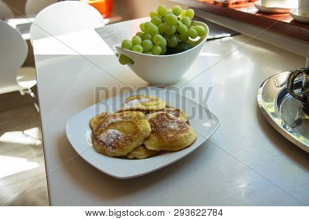 Traditional Polish Pancakes On A Plate And Green Grapes On A Kitchen Counter - Sweet Pancakes Sprink