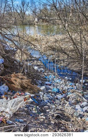 Garbage Thrown To The Bank Of The River, The Topic Of Environmental Pollution