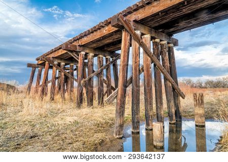 railroad timber trestle destroyed by river flooding - St Vrain Creek near Platteville, Colorado