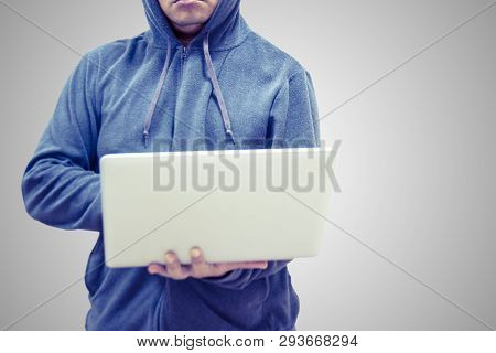 The Hacker Man  Do Hacking The Password And Theift The Data By Use Latop Wearing The Jacket Wiyh Hoo