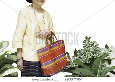 Senior Woman With Coloruful Hand Bag Isolated In Clipping Path.