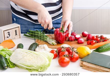 Woman Hands Cutting Vegetables On Wooden Background