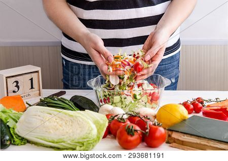 Woman Hands Adding Vegetables To Dishes