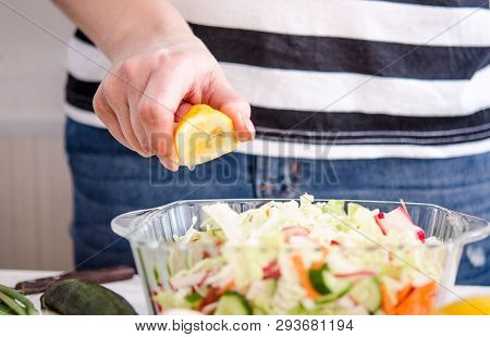 Woman Hands Adding Vegetables To Dishes