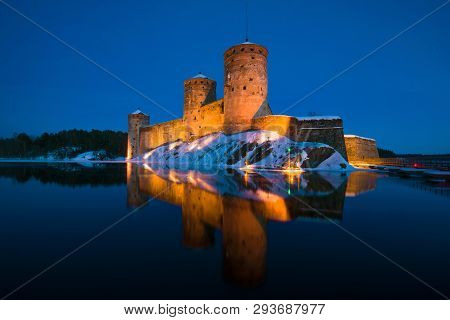 The Ancient Olavinlinna Fortress In The Night Landscape. Savonlinna, Finland