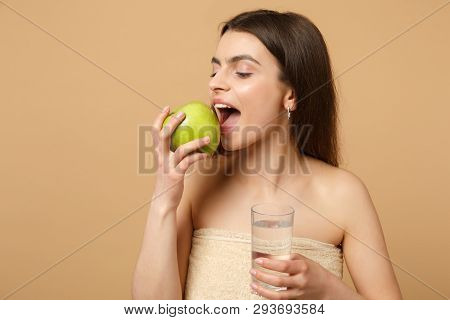 Close Up Half Naked Woman 20s With Perfect Skin, Nude Make Up Hold Apple, Water Isolated On Beige Pa