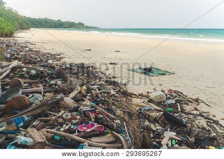 Beach Pollution. Plastic Bottles And Other Trash On Sea Beach. Garbage Nailed By A Wave From The Sea