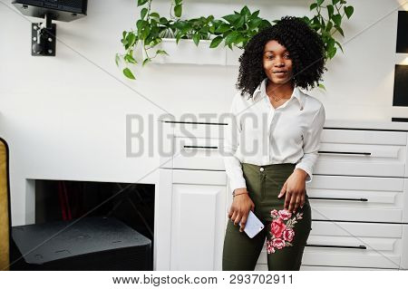 Сheerful Business African American Lady With Afro Hair, Wear White Blouse And Green Pants Posed In C