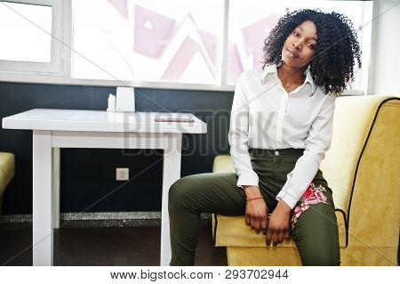 Сheerful Business African American Lady With Afro Hair, Wear White Blouse And Green Pants Posed In C