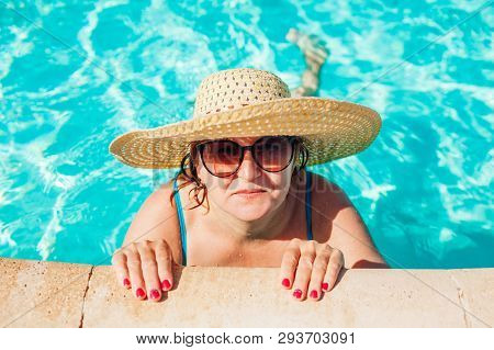 Senior Woman Relaxing In Hotel Swimming Pool. People Enjoying Summer Vacation. All Inclusive