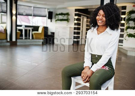 Сheerful Business African American Lady With Afro Hair, Wear White Blouse And Green Pants Posed In C
