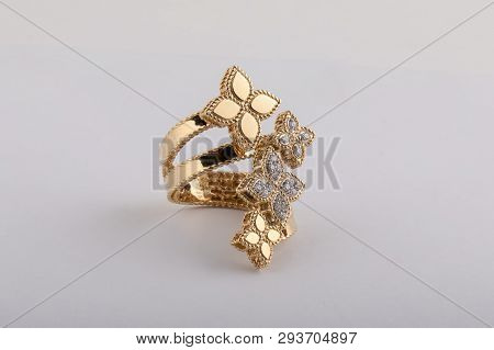 Womens Ring In Rose Gold With Diamonds In The Shape Of Flowers With A Fringe Isolated On A White Bac