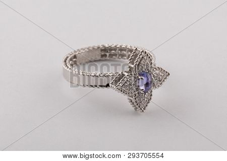 Womens Silver Ring With Blue Diamond In The Center, In The Shape Of A Flower Isolated On A White Bac