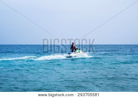 Young Man On Jet Ski, Tropical Ocean, Vacation Concept. Marine Entertainment In The Summer At The Se