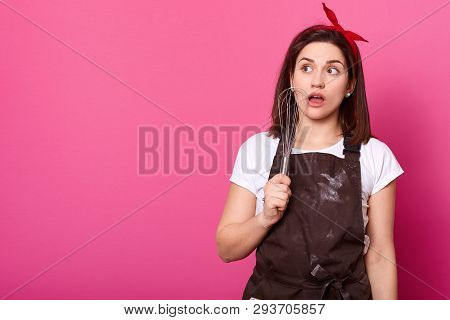 Brunette Young Lady In Brown Apron Smeared With Flour, T Shirt And Bright Red Headband, Stands With 