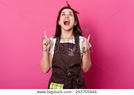 Portrait Of Brunette Energetic Girl In Dark Brown Apron Smeared With Flour, White Tshirt And Red Hai