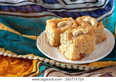 Basbousa Or Namoora Traditional Arabic Semolina Cake With Cashew Nuts And Syrup. East Pattern Backgr