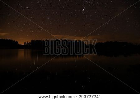 Night Sky With Starts In A  Conemara Lake With Pine Forest Around