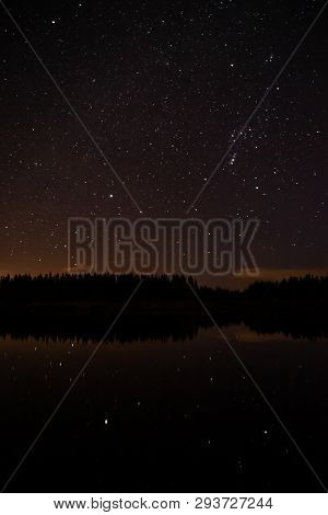 Night Sky With Starts In A  Conemara Lake With Pine Forest Around
