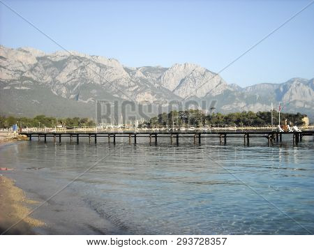 Kemer Antalia Nice View Of The Sea. Beach Kemer Antalia With Sand And Mountains, The Sea With The Sh