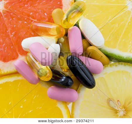 Group Of Pills On Fruit Slices (orange, Lemon, Lime, Grape Fruit) .