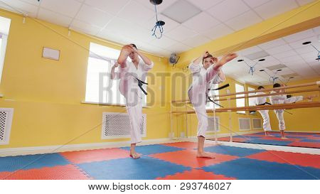 Two Men Training Their Aikido Skills In The Studio. Training Their Kick
