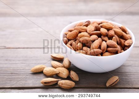 Bowl Of Almonds On A Grey Background
