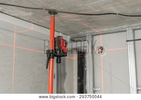 Laser Measurement During Renovation. Construction Tools And Equipment. Red Laser Light Lines For Lev
