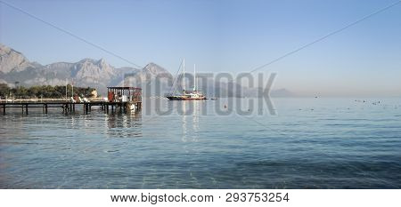 Kemer Antalia Nice View Of The Sea. Beach Kemer Antalia With Sand And Mountains, The Sea With The Sh